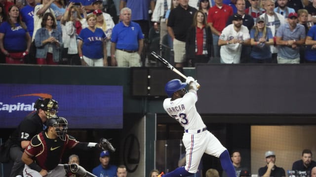 Oct 27, 2023; Arlington, TX, USA; Texas Rangers right fielder Adolis Garcia (53) hits an RBI single during the first inning against the Arizona Diamondbacks in game one of the 2023 World Series at Globe Life Field. Mandatory Credit: Rob Schumacher-Arizona Republic